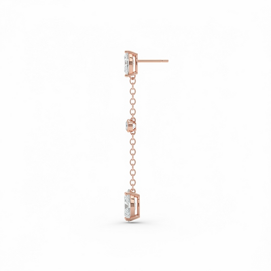 Rose gold earring with chain and clear gemstones on a white background