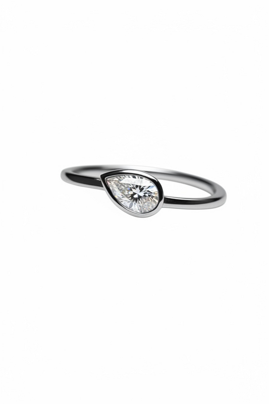 Teardrop-shaped diamond ring on a white background