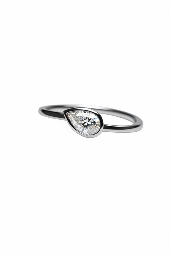 Teardrop-shaped diamond ring on a white background