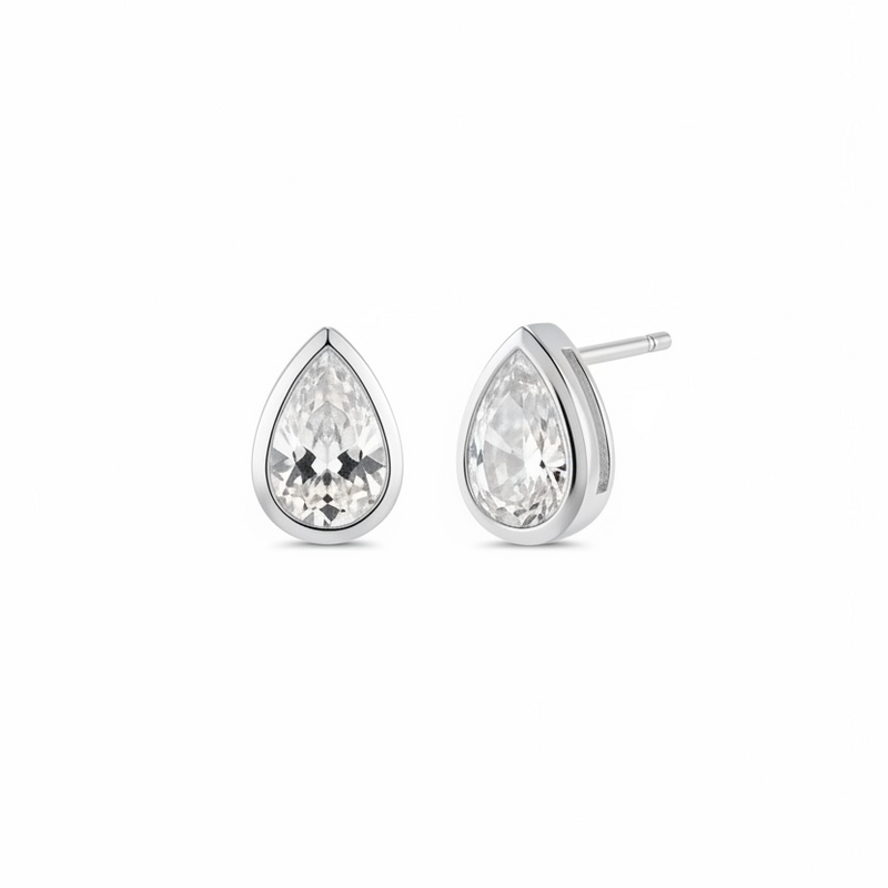 Teardrop-shaped gold earrings with clear diamond on a white background
